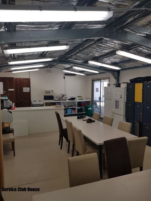 Dining table, kitchen and lockers inside the Service club house