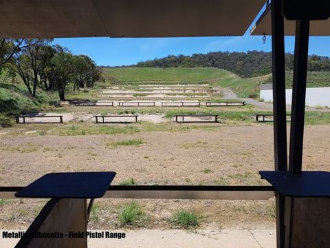 Rows of target stands stepping up the hill from 25 to 100 metres