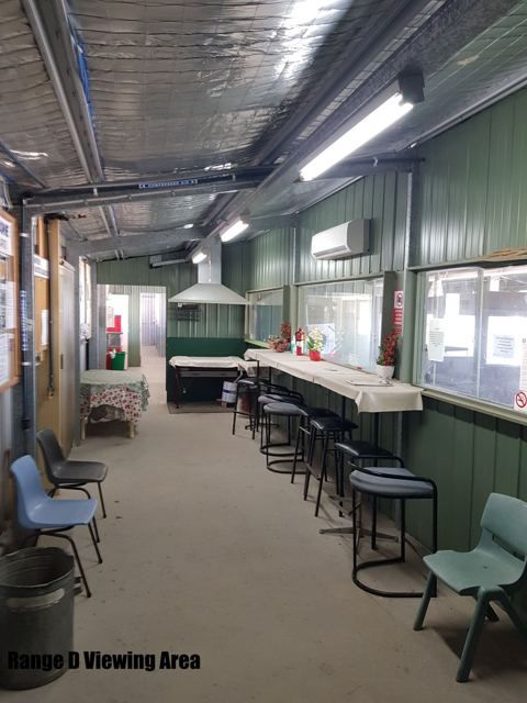 Stools and a bench along the windows of the Range D viewing area
